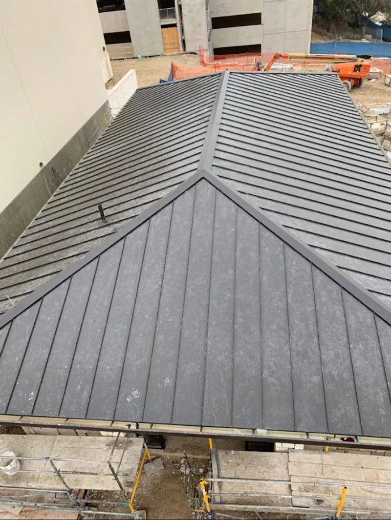 Commercial metal roof construction with crane equipment in Lutherville