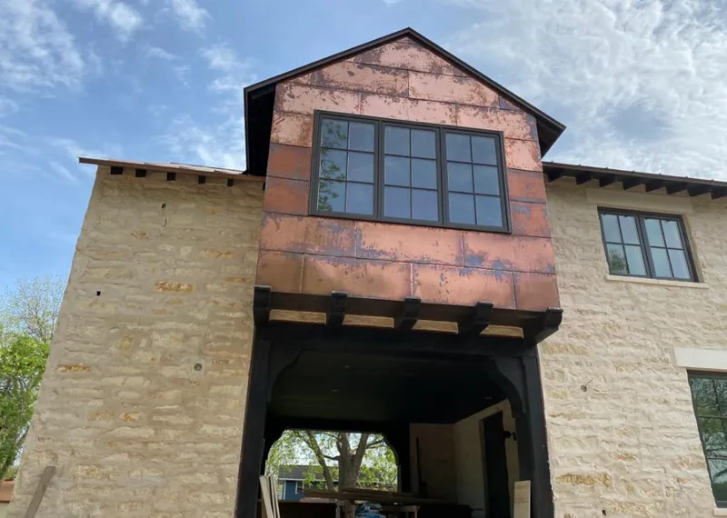 Copper metal panel facade on a stone building for Skylight Installation in Lutherville